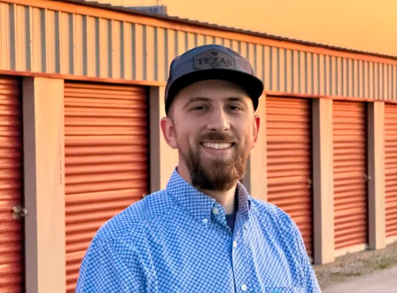 Jed at Oak Storage in Elm Mott, in front of the drive-up units
